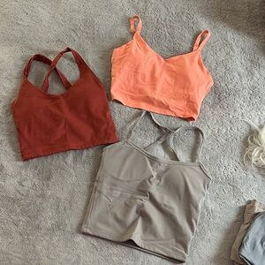 Set of Three Workout Crop Tops in Red, Orange, and Tan. Gilly Hicks and Athleta